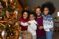 Portrait happy African American family decorating Christmas tree at home Royalty Free Stock Photo