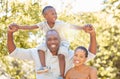 Portrait happy african american family of three spending quality time together in the park during summer. Mother, father Royalty Free Stock Photo