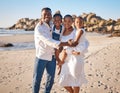 Portrait of a happy african american family with two children standing together on the beach. Loving mother and father Royalty Free Stock Photo