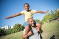 Portrait of happy African American father holding son on his neck Royalty Free Stock Photo