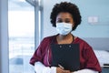 Portrait of happy african american female doctor wearing scrubs and face mask Royalty Free Stock Photo