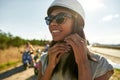 Portrait of happy african american girl putting on helmet Royalty Free Stock Photo