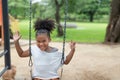 Portrait of happy African American little girl smiling look at camera at playground in the park Royalty Free Stock Photo