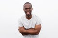 Happy african american man laughing with arms crossed while posing against white background Royalty Free Stock Photo