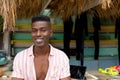 Portrait of happy african american man leaning on counter of surf hire beach shack, copy space Royalty Free Stock Photo