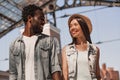 Portrait of happy african american man looking at his asian girlfriend in shopping mall Royalty Free Stock Photo