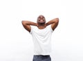 Happy african american man relaxing with hands behind head against white background Royalty Free Stock Photo