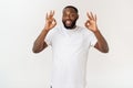 Portrait of happy african-american man showing ok sign and smiling, over white background. Royalty Free Stock Photo