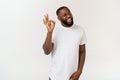 Portrait of happy african-american man showing ok sign and smiling, over white background. Royalty Free Stock Photo