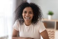 Portrait of smiling black millennial girl posing at home Royalty Free Stock Photo