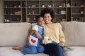 Portrait of happy african american mother cuddling kid daughter. Royalty Free Stock Photo