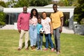 Portrait of happy african american multi-generational family standing in front yard Royalty Free Stock Photo