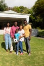 Portrait of happy african american multi-generational family standing together in front yard Royalty Free Stock Photo
