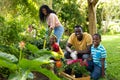 Portrait of happy african american siblings gardening with parents in backyard on weekend Royalty Free Stock Photo