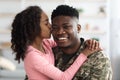 Portrait of happy african american teen girl kissing dad soldier Royalty Free Stock Photo