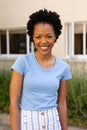 Portrait of happy african american young afro woman smiling while standing outdoors Royalty Free Stock Photo