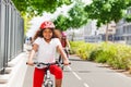 Happy African girl riding bicycle on cycle path Royalty Free Stock Photo