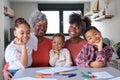 African horizontal extended family looking at camera and smiling at home. Royalty Free Stock Photo