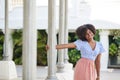 Happy afro american woman holding column looking away Royalty Free Stock Photo