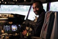 Portrait of happy airliner sitting in airplane cockpit ready to fly Royalty Free Stock Photo