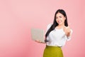 Woman confident smiling face holding using laptop computer and showing thumb up Royalty Free Stock Photo