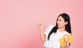 Woman confident smiling holding orange book open pointing finger Royalty Free Stock Photo