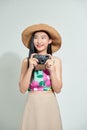 Portrait of happy Asian beautiful young woman photographer holding vintage digital mirrorless photo camera on hands Royalty Free Stock Photo
