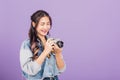 Young woman smiling excited wear denims holding vintage photo camera Royalty Free Stock Photo