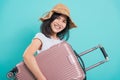 Woman standing wear white t-shirt, holidays travel concept, her hugging suitcase Royalty Free Stock Photo