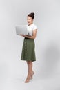 Portrait of a happy asian businesswoman working on laptop computer isolated over white background Royalty Free Stock Photo