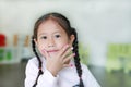 Portrait of Happy asian child girl showing her nails with fashion jewels