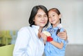 Portrait of happy Asian daughter Pay respect and give Thai traditional jasmine garland to mother. Royalty Free Stock Photo