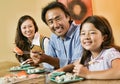 Portrait of happy asian family eating sushi at home Royalty Free Stock Photo