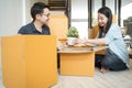 Portrait of happy Asian family moving to new house with cardboard boxes. Royalty Free Stock Photo