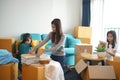 Portrait of happy Asian family moving to new house with cardboard boxes. Royalty Free Stock Photo