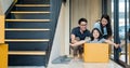 Portrait of happy Asian family moving to new house with cardboard boxes and playing cardboard box. Royalty Free Stock Photo