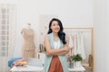 Portrait of happy Asian fashion designer businesswoman at studio. Smiling, standing, looking at camera Royalty Free Stock Photo