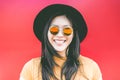 Portrait of happy asian girl smiling with vintage sunglasses - Young chinese woman having fun posing in front of the camera - Royalty Free Stock Photo