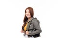 Portrait of happy Asian girl student wearing denim jacket with backpack smiling and looking at camera isolated on white background Royalty Free Stock Photo