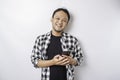 A portrait of a happy Asian man is smiling while holding on his phone, isolated by white background Royalty Free Stock Photo