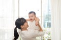 Portrait of happy asian mother and baby having fun together at h Royalty Free Stock Photo