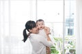 Portrait of happy asian mother and baby having fun together at h Royalty Free Stock Photo