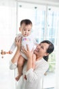 Portrait of happy asian mother and baby having fun together at h Royalty Free Stock Photo