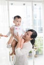 Portrait of happy asian mother and baby having fun together at h Royalty Free Stock Photo