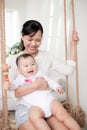 Portrait of happy asian mother and baby having fun together at h Royalty Free Stock Photo