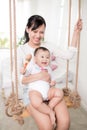 Portrait of happy asian mother and baby having fun together at h Royalty Free Stock Photo