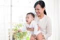 Portrait of happy asian mother and baby having fun together at h Royalty Free Stock Photo