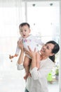 Portrait of happy asian mother and baby having fun together at h Royalty Free Stock Photo