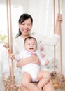 Portrait of happy asian mother and baby having fun together at h Royalty Free Stock Photo