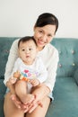 Portrait of happy asian mother and baby having fun together at h Royalty Free Stock Photo